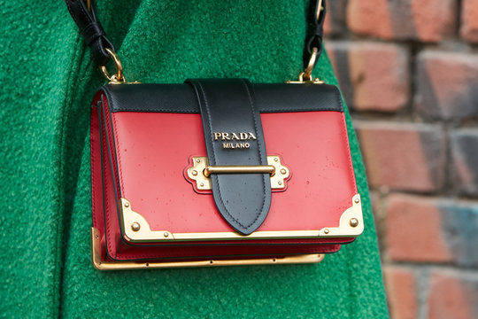 Woman With Red And Black Prada Leather Bag With Golden Details And Green Coat On February 22, 2018 In Milan, Italy