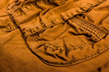 clothing items stonewashed cotton fabric texture with seams, clasps, buttons and rivets, macro