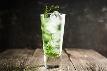 Sweet tequila based green cocktail with tarragon and rosemary. Selective focus. Shallow depth of field.