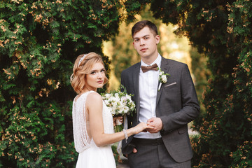 Bride and groom. Portrait of a man in a suit and a woman of a blonde in a white dress on nature on the wedding day.