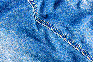 clothing items blue stonewashed faded jeans cotton fabric texture with seams, clasps, buttons and...