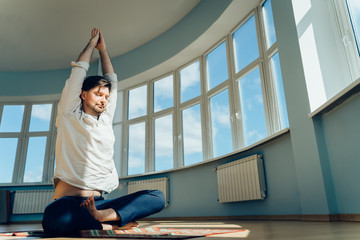 Man practice yoga. Young attractive male doing breathing exercises. Guy meditating at home along...