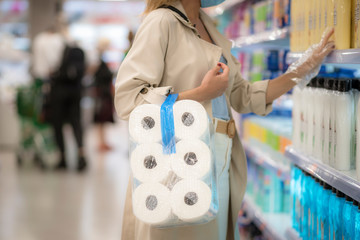 girl in the supermarket with toilet paper