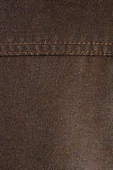 clothing items stonewashed cotton fabric texture with seams, clasps, buttons and rivets, macro