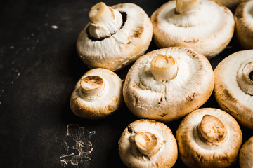 Freshly harvested mushrooms on the rustic wooden background. Selective focus. Shallow depth of field.
