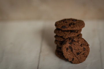Stack of chocolate chip cookie on white wooden table