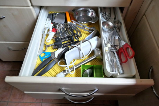 Kitchen utensils in an open drawer
