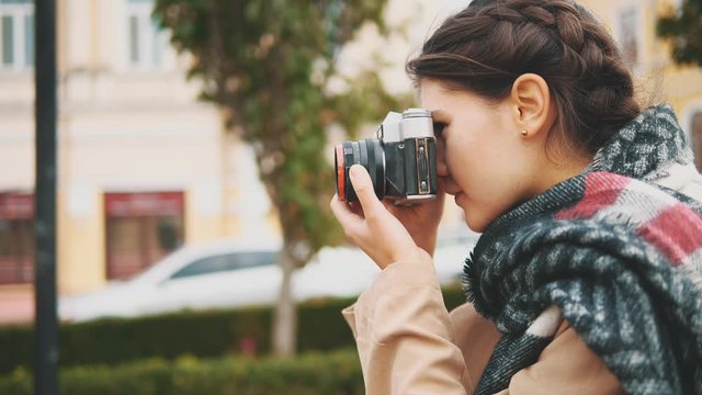 Adorable and interested girl is taking photoes. Crop. Copy space. Action. Motion. 4K.