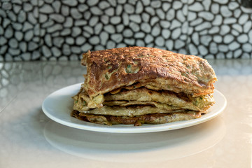 "Murtabak" or pancake with mixed meat or chicken and vegetable on the plate