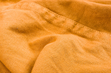 clothing items stonewashed cotton fabric texture with seams, clasps, buttons and rivets, macro