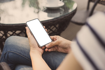 cell phone Mockup image blank white screen.woman hand holding texting using mobile on desk at coffee shop.background empty space for advertise.work people contact marketing business,technology