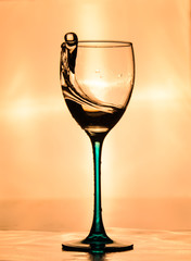Beautiful wine glass with splash of water