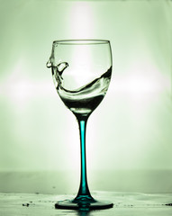 glass of water on green background