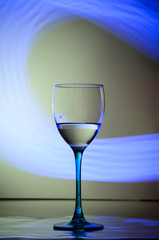 Modern glass of wine on blue