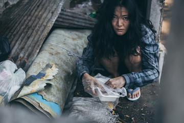 poor people,homeless or beggar begging for help sitting at dirty slum.concept for poverty...