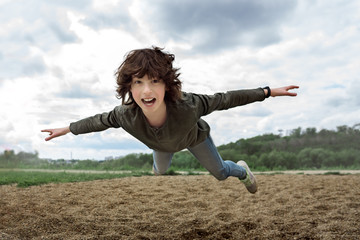 Joyful boy in flight (levitation effect).