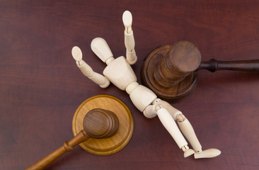 Wooden figure and two judge gavels. Different courts concept.