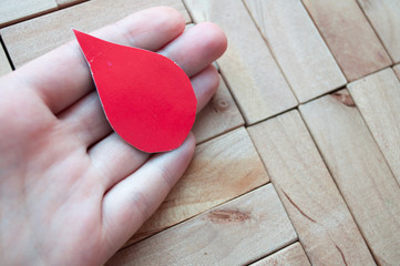 World Blood Donor Day. World Hemophilia Day. Hand holds a drop of blood. World Hemophilia Day....