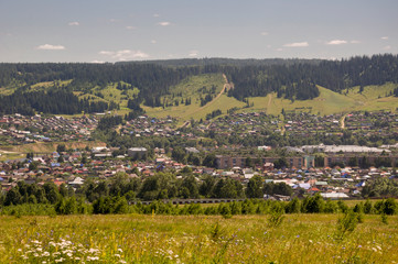 Suburb and villages. Big mountains and dark green forests far away. Trees and their shadows on the...