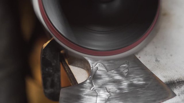 The master polishes the axe, close-up