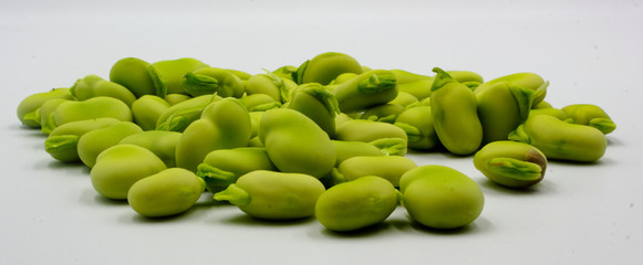 panoramic pile of fresh shelled broad beans isolated on a white background