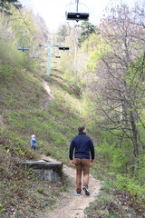 Fototapeta na wymiar Family walk or hike through the mountain forest in early spring
