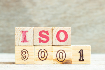 Alphabet letter in word iso 9001 on wood background