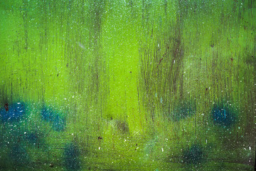 Texture of a rusty metal surface with white, green, salt, evergreen, dark blue, blue, aged cracked paint. Rusty and scratched painted metal wall