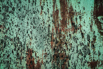 Texture of a rusty metal surface with white, green, salt, evergreen, dark blue, blue, aged cracked paint. Rusty and scratched painted metal wall