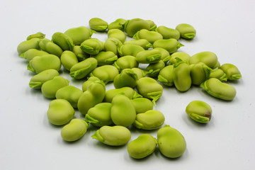 pile of fresh shelled broad beans isolated on a white background