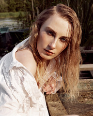 Portrait of a girl in a white dress on the nature