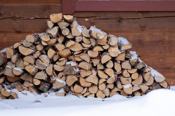 A pile of firewood on the snow