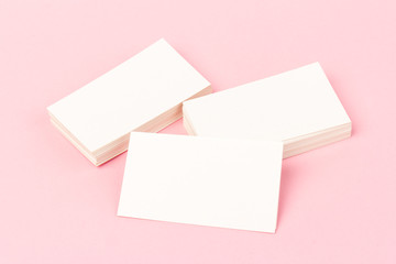 Obraz na płótnie Canvas white blank business cards on pink background in close-up