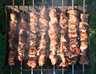 Shish kebab. Pork or lamb meat pieces being fried on a charcoal grill. Frying grilled pieces of meat during the rest.