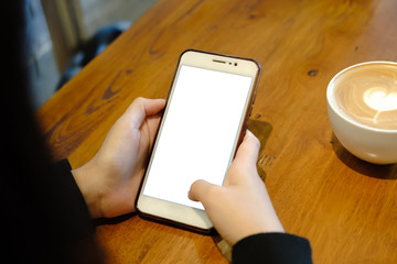 Close up of woman using cell phone sending massages  for shopping online within the cafe.having sunbath.Phone with black screen,texting,video calls.