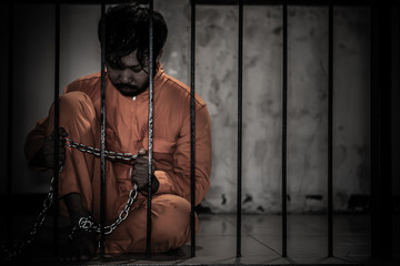 Asian man desperate at the iron prison,prisoner concept,thailand people,Hope to be free,Serious...