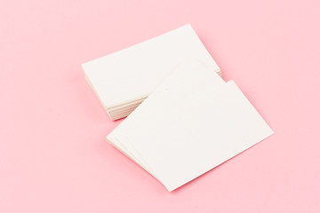 white blank business cards on pink  background in close-up