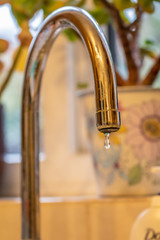 Dripping chrome tap letting water leak out