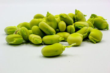 pile of fresh shelled broad beans isolated on a white background