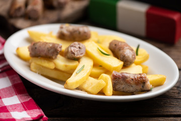 White plate of  italian sausage and potatoes