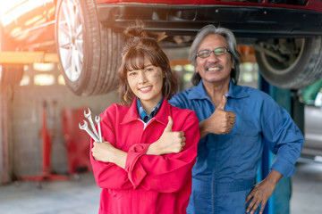 Team of Asian Mechanics Smiling and Giving Thumb Up.