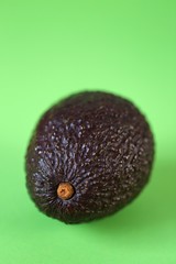 Avocado fruit.  ripe avocado on a  green background.Useful dietary product. Healthy Fat. Organic Bio Fresh Avocado