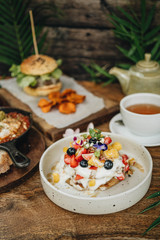 Fototapeta premium Dinner with gamburger, shakshuka and pancakes and coffee