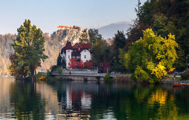Sunny morning scene on mountains lake. Boats at the pier of the Bled Island, Lake Bled, Slovenia....