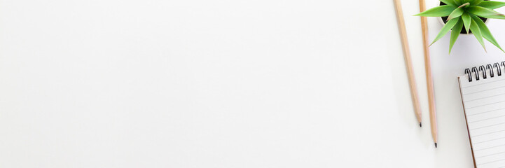 White desk with office supplies. Copy space. Panoramic photo