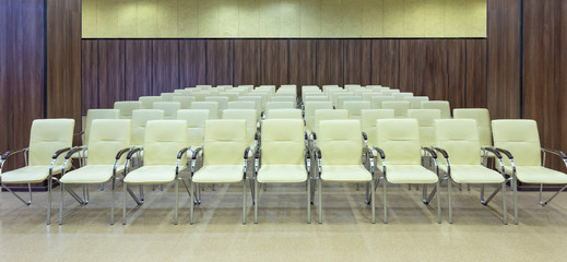 Interior of audience. Many chairs in conference room