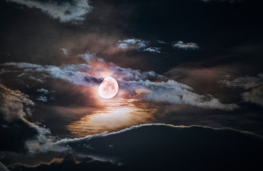 Fototapeta na wymiar Beautiful night sky with bright moon and dark clouds.