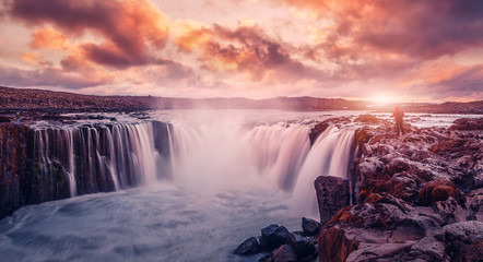 Iceland scenery during sunset. Awesome nature landscape. powerfull Waterfall with colorful sky...