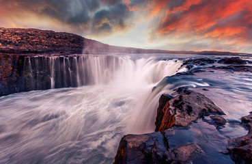 Iceland scenery during sunset. Awesome nature landscape. powerfull Waterfall with colorful sky...