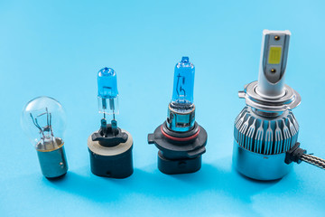 Electric car bulbs for headlight isolated on color background. Modern glass automotive lamp